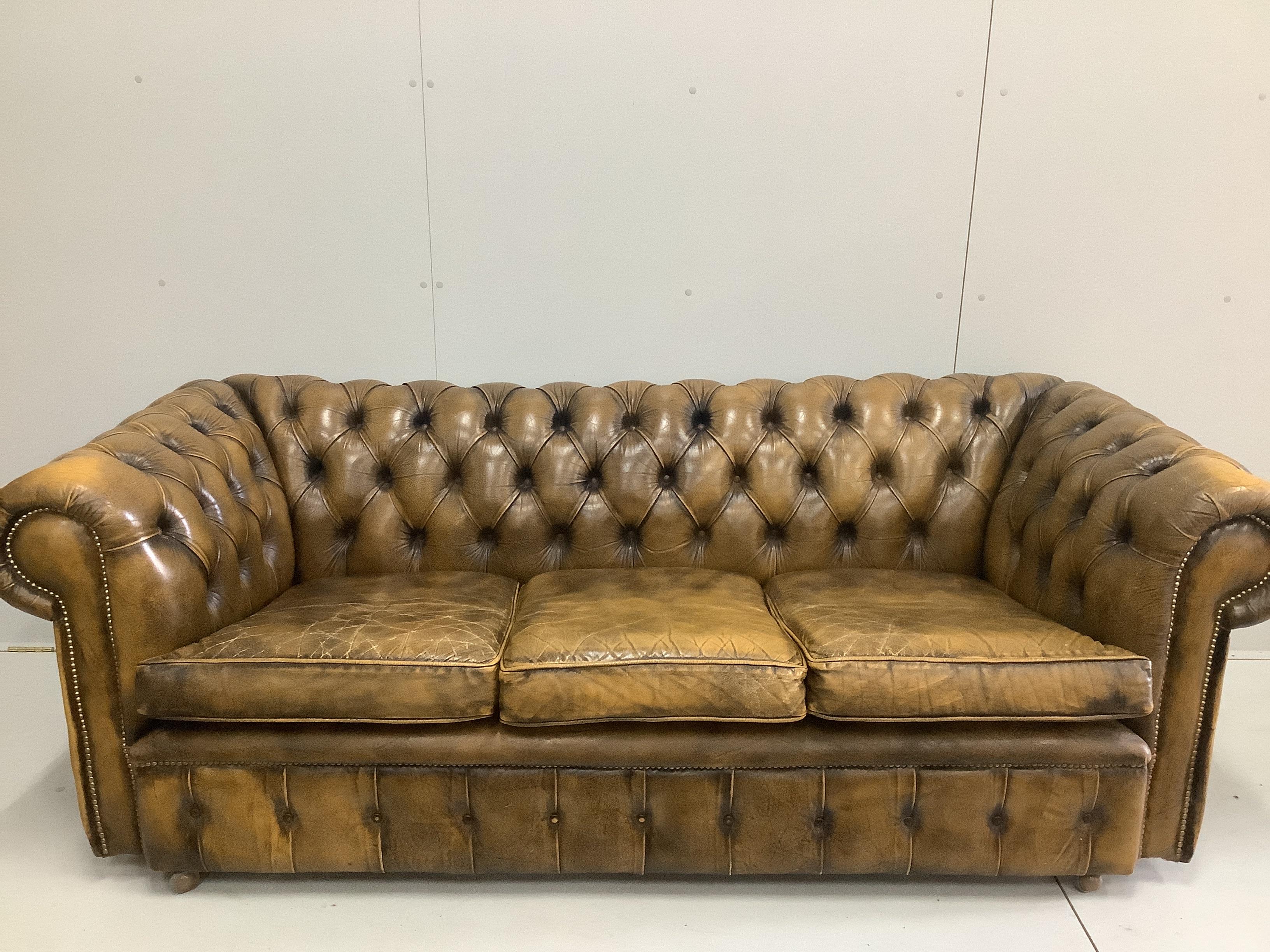 A Victorian style buttoned leather Chesterfield settee, width 210cm, depth 88cm, height 74cm
